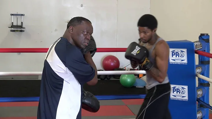 Raymond Merrill III working pads with trainer Jeff...
