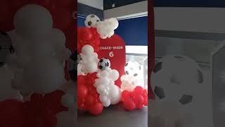 Football themed backdrop and balloon arch.