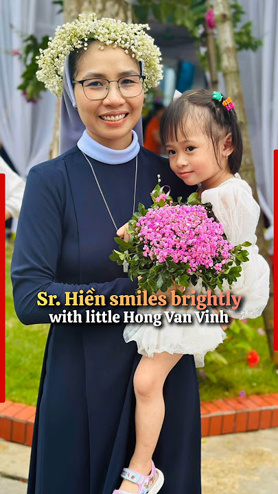 Sr. Hiền smiles brightly with little Hong Van Vinh on her special vow day #sister #nun #catholic
