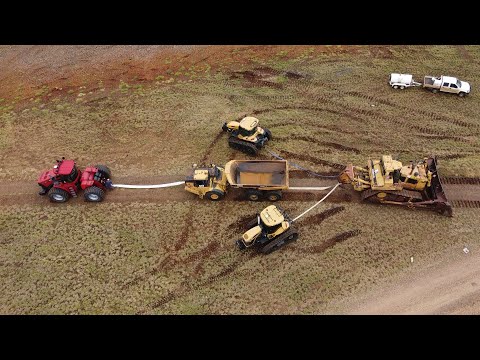 Big D11 Bulldozer Drags Tractors and Dump Truck