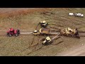 Big d11 bulldozer drags tractors and dump truck