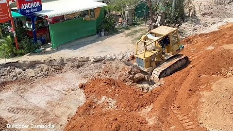 Opening of a new large-scale construction site pouring red soil to make a good road & dozer Kumat’su