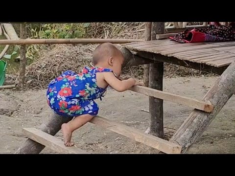 Single mother - making a crib for her child to sit on, bathing her child, cooking rice