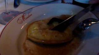 Raviolo Al Vovo From Maialino Being Sliced Open To Cut The Egg Yolk