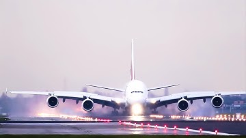 A380 Emirates, powerful Reverse thrust on a wet runway.