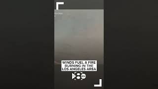 Winds fuel a fire burning in the Los Angeles area, prompting hundreds of evacuations.