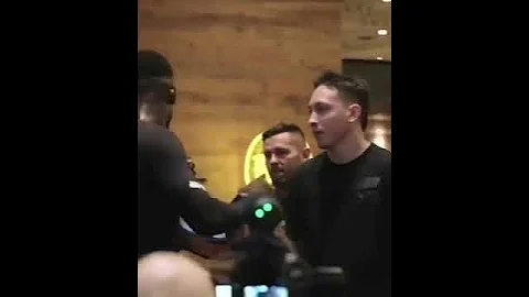 Israel Adesanya holding pads for fans and giving them tickets to the fight