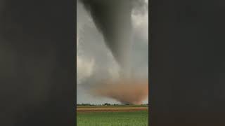 Incredible tornado in Texas with a red debris cloud churning up dust. This twister was rated EF2.