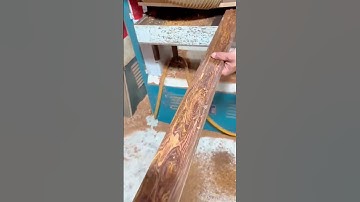 Sanding wooden planks smoothly using an automatic belt sander for polished surface finishing