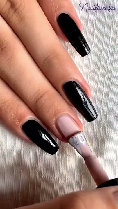 Premium Photo | A woman's nails with a silver and black nail art design