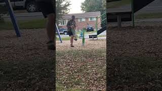 Dad takes his boy off spinning ride at playground and stands him up then he falls over