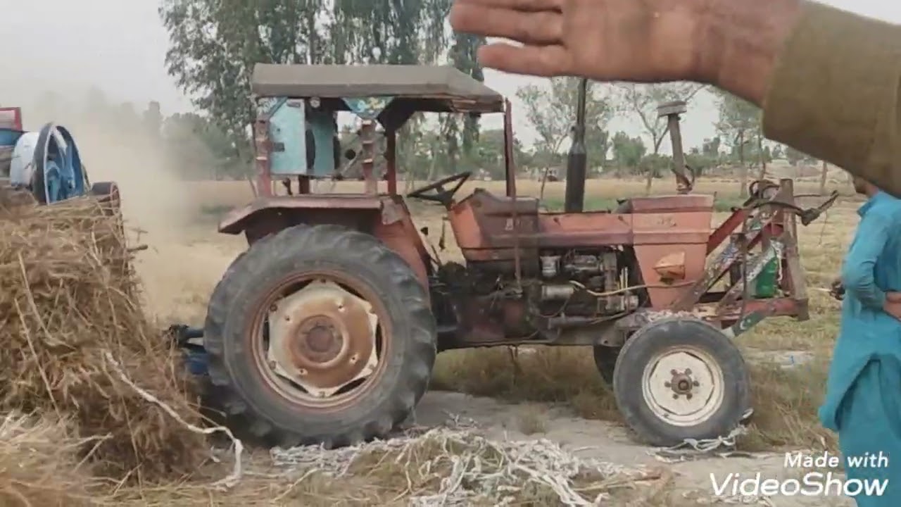 Al Ghazi Tractor on Wheat thresher Dogar sons