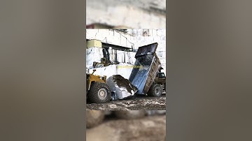 Wheel Loader Loading Marble Blocks into Dump Truck.