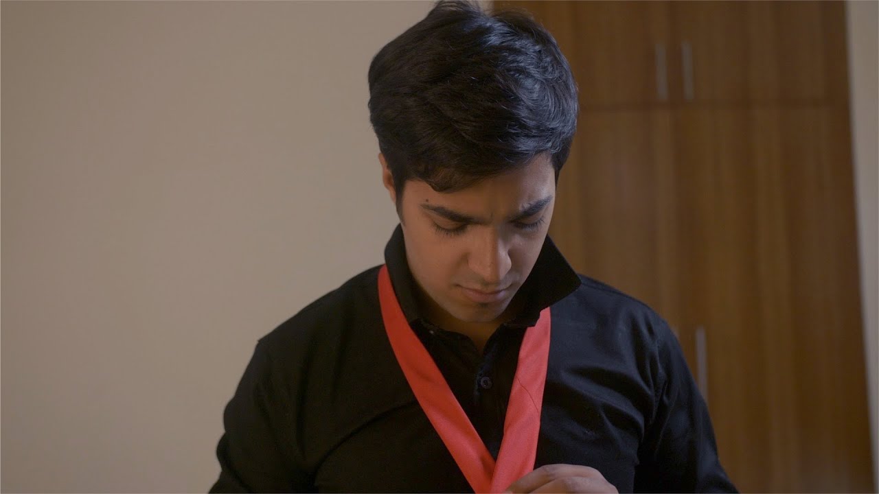 Young Indian businessman putting on a red tie. Getting ready f... | Indian Stock Footage | Knot9