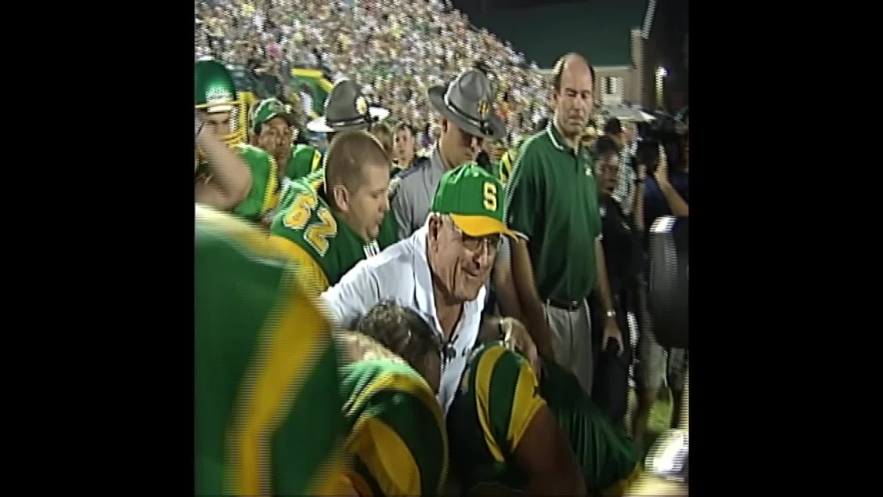 Athletes celebrate with Coach McKissick after his 500th win