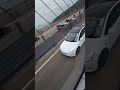 A white Tesla was driving on a Hong Kong Highway