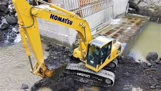 Excavators And Trucks Digging Moving Rocks And Dirt on The Dam Construction