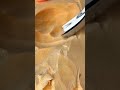 Carving a hollow shape into a smooth piece of wood using a curved metal gouge woodworking chisel