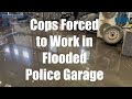 Cops work in flooded garage