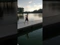 Kid swims in lake with only his underwear on