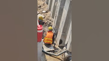 Breaking concrete sheet pile for drainage outlet