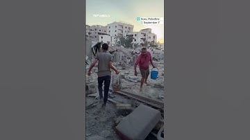 Palestinian child cries as he pulls his birds out of the rubble following Israeli air strike
