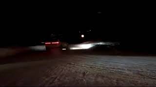 Two Saab 9-4X drifting in snow.