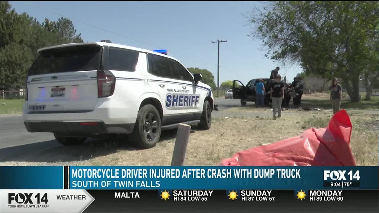 Motorcycle driver injured after crash with dump truck - YouTube