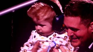 Michael Buble' picks up Noah his son during show