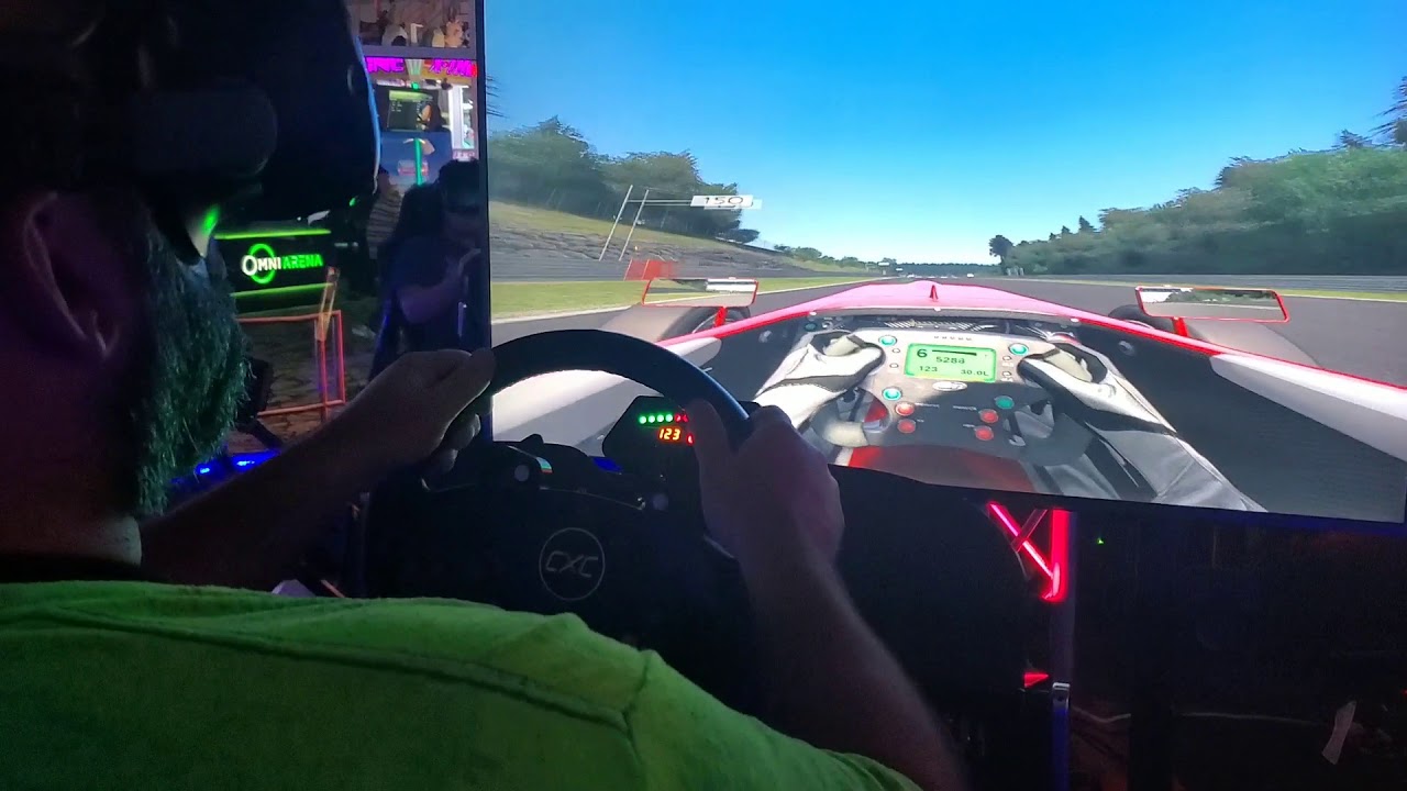 Ken playing a virtual reality racing game at Andretti Indoor Karting