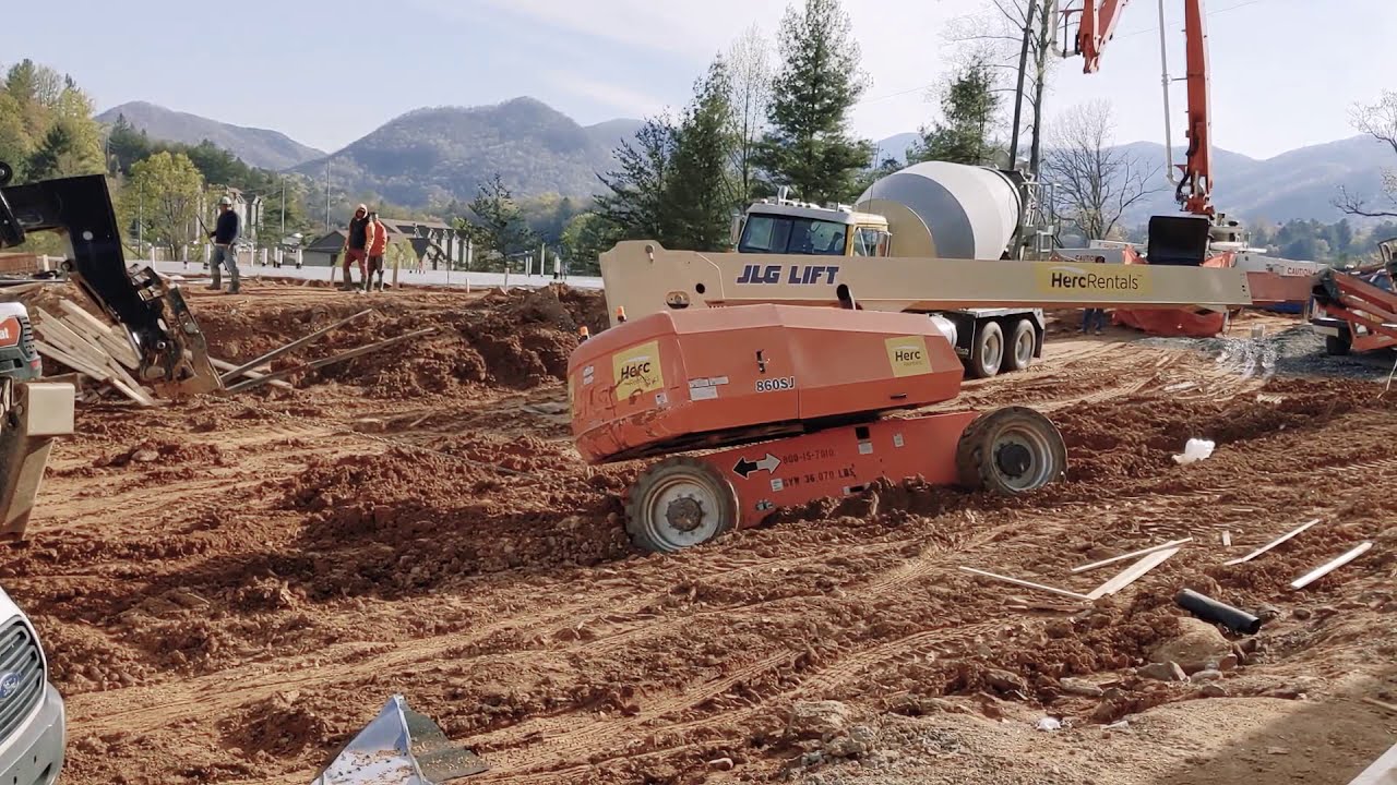 Dangerous way to try to get a boom lift out of mud YouTube