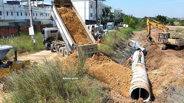 New project Landfill by Heavy dump truck unloading soil delete Drainage & skill operator pushing 