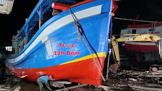 Launching large fishing boats at night