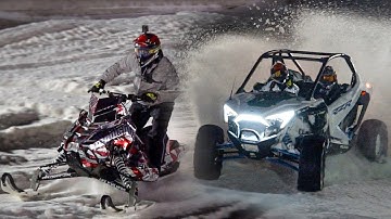 Polaris RZR vs. Snowmobile on Snowcross track!!