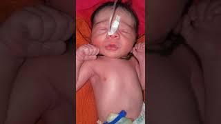 Newborn worn a black thread in his throat this thread sign love of mother and parents