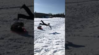 Sled crashes into boy and he lands in scorpion position