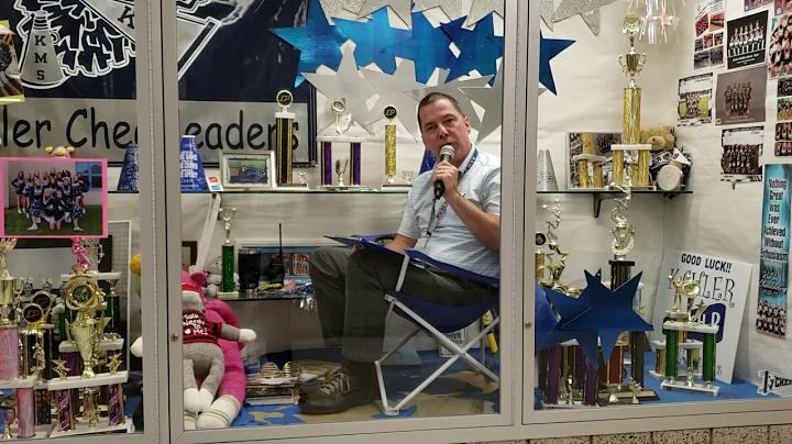 Kahler Principal Ken Newton sits in display case f...
