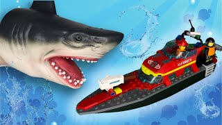 The shark attacks the LEGO Fire Rescue Boat with the rescuer. LEGO City