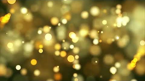 Golden bokeh lights fading and moving slowly on warm background   Free HD Video Clips