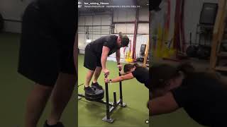 Trainers having some fun with the sled