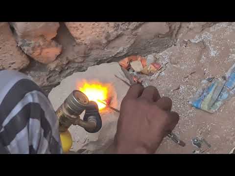 Gold smelting to produce gold Doré buttons in an ore-crushing facility at Zouérate, Mauritania.