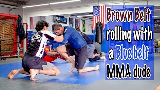 Brown belt rolling with a Blue belt MMA dude