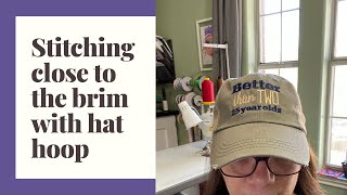 Stitching close to the brim of a hat with a brother hat hoop