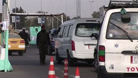 Iraqi forces search cars at Baghdad checkpoint after kidnapping