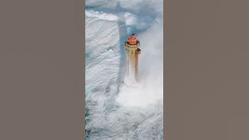 Huge waves crashing against a lighthouse in France 🌊