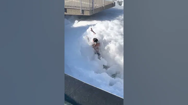 Guy Enjoying Bubbles in a Fountain Filled With Soap
