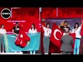 Athletes fight over flags on winners podium