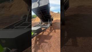 Dumping a load of wood chips with a dump trailer