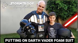 Putting on Darth Vader foam suit