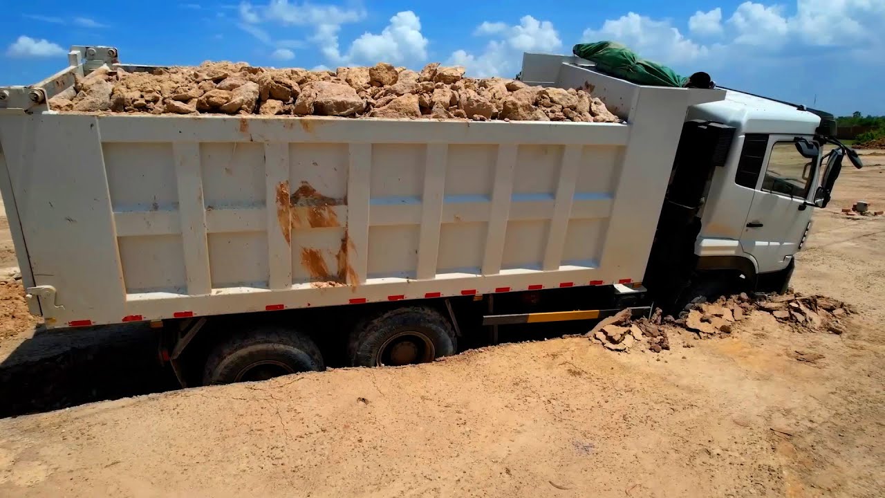 Impressive a dump truck stuck is rescued by skills operator heavy bulldozer DH17C2 at landfill site